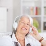 Modern senior woman listening to music