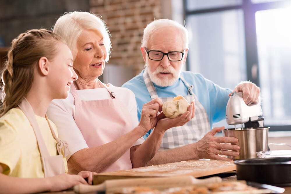Grandparents baking with granddaughter