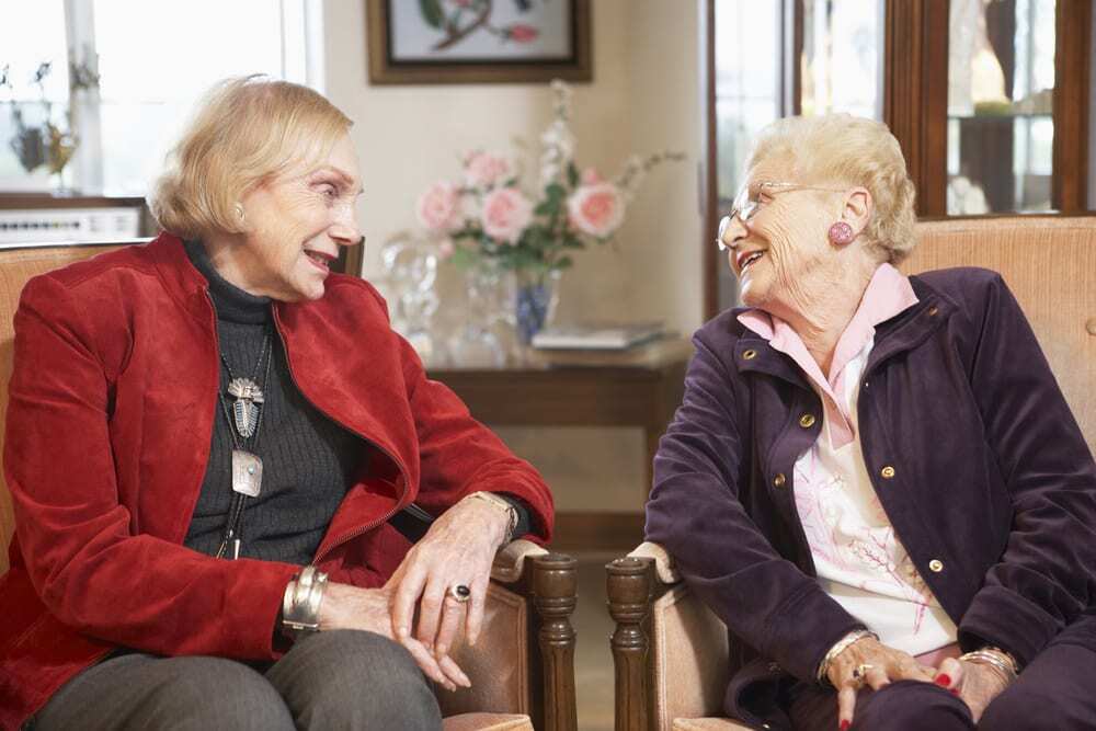 Two senior women talking and smiling