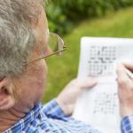 Close-up of senior man doing crossword puzzle