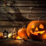 Jack-o-lantern, pumpkins, lantern, and leaves in the dark.jpg
