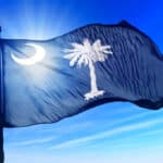 South Carolina flag flying over blue sky