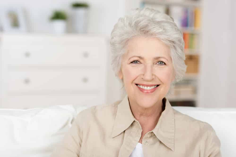 Senior woman smiling at home
