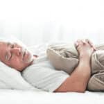 Senior man sleeping peacefully in bed