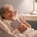Senior woman relaxed in bed after reading, book on chest